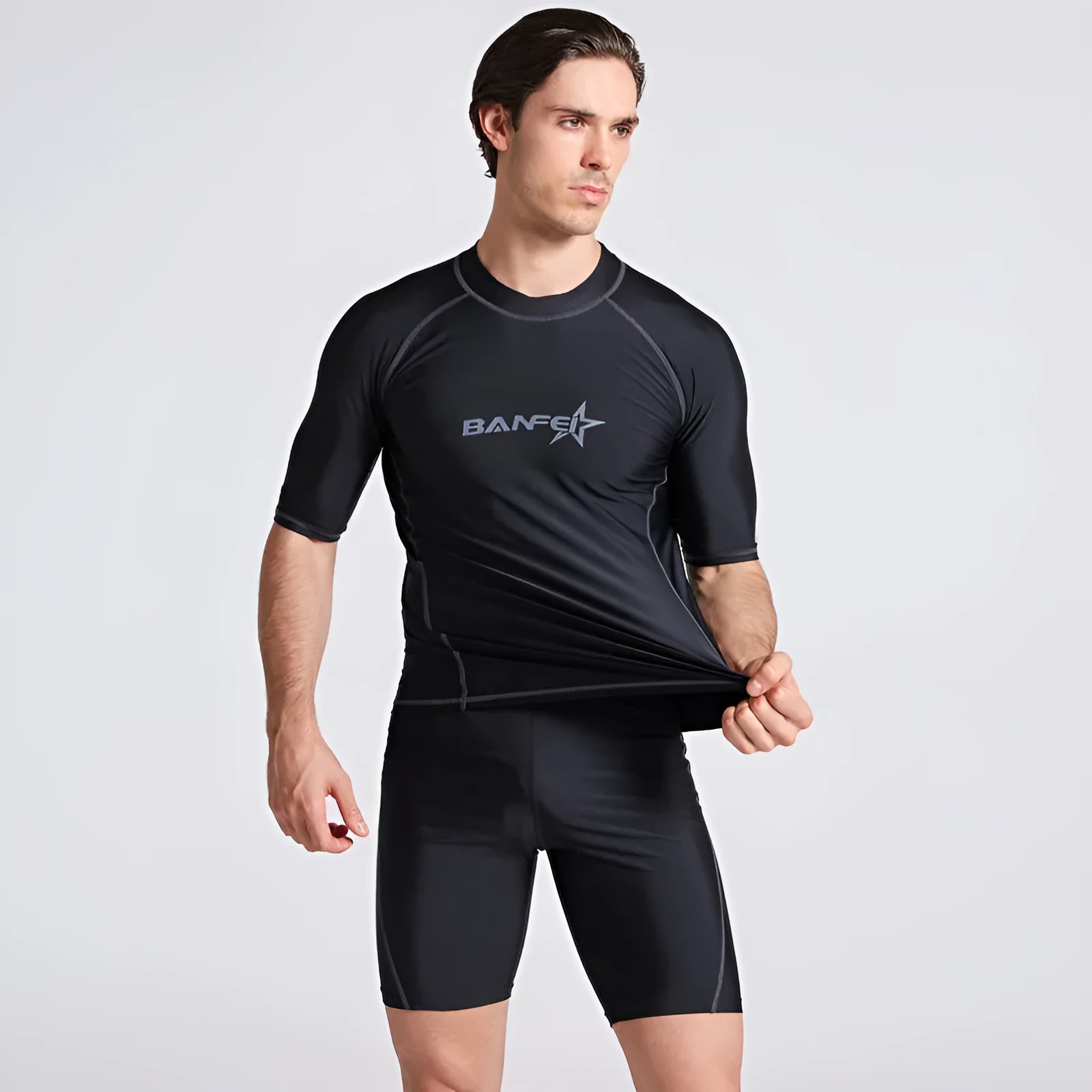 Men's quick-dry half sleeve swimsuit suit for snorkelling, showing separate nylon top and pants.