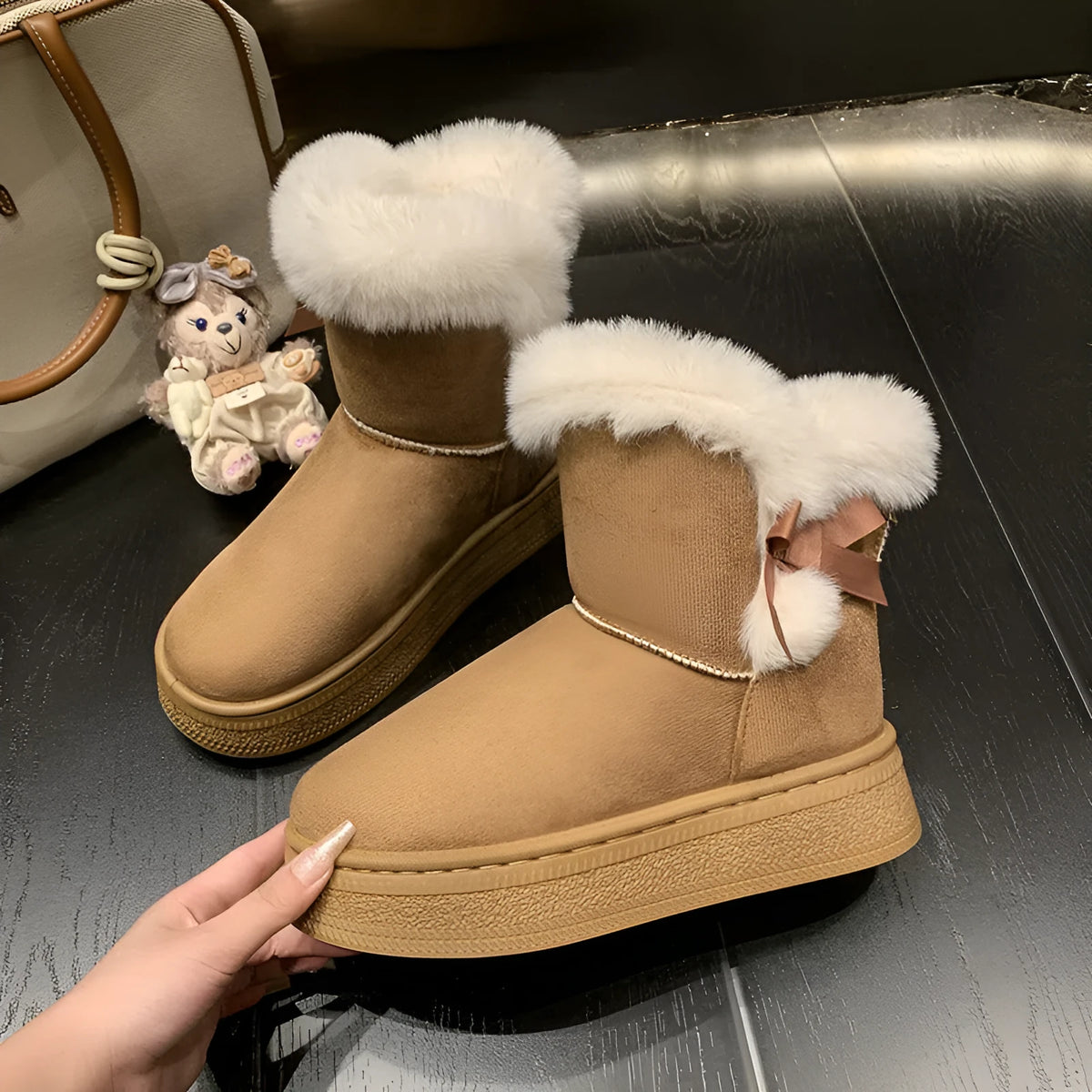 Women's mid-calf suede snow boots with faux fur lining, 1–3 cm thick rubber sole, and bow tie detail, shown in brown, black, or white.