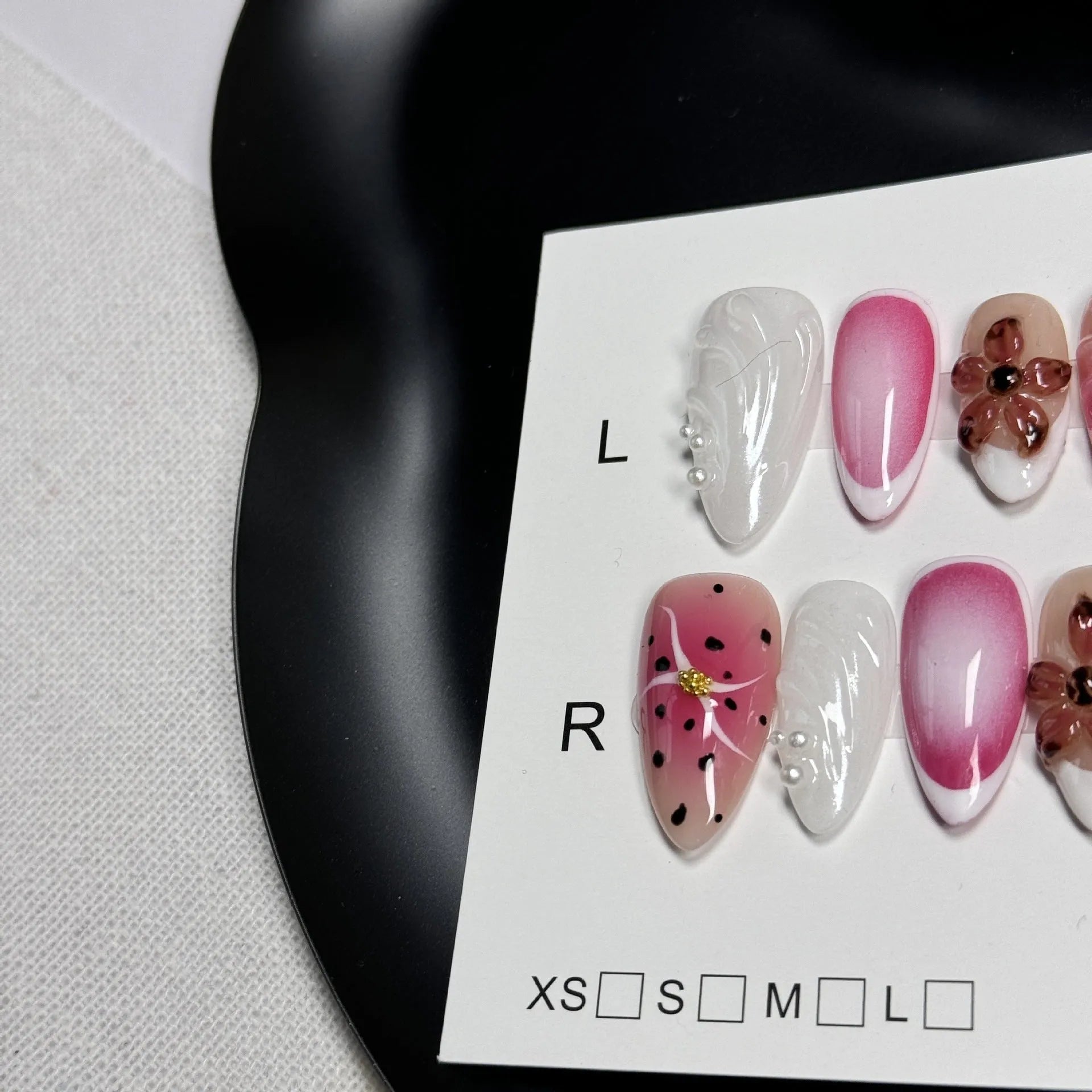 Close-up of hand-painted 3D carved nail art patches with colourful embossed candy patterns.