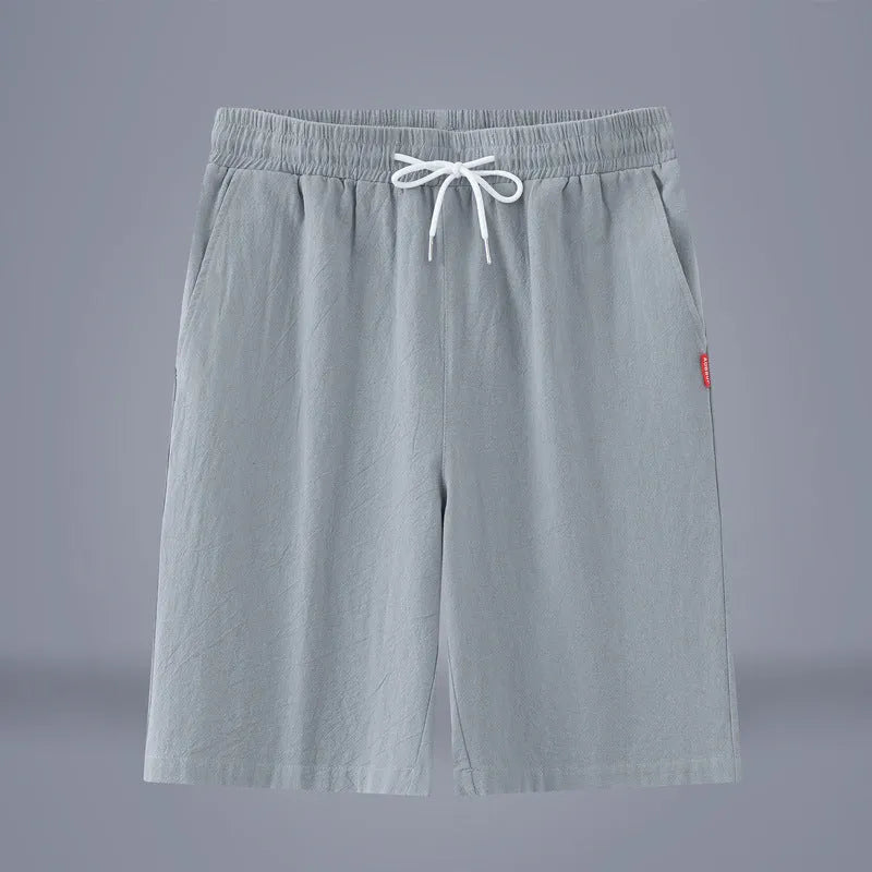 Solid colour cotton-linen cropped trousers with a drawstring waist on a hanger.