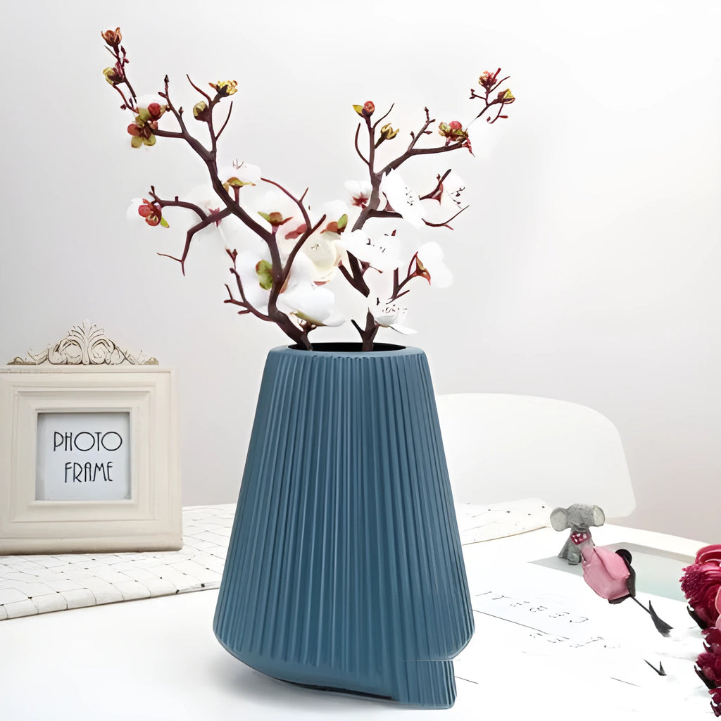Blue melamine plastic decorative flower vase measuring 16cm by 20cm on a desktop.