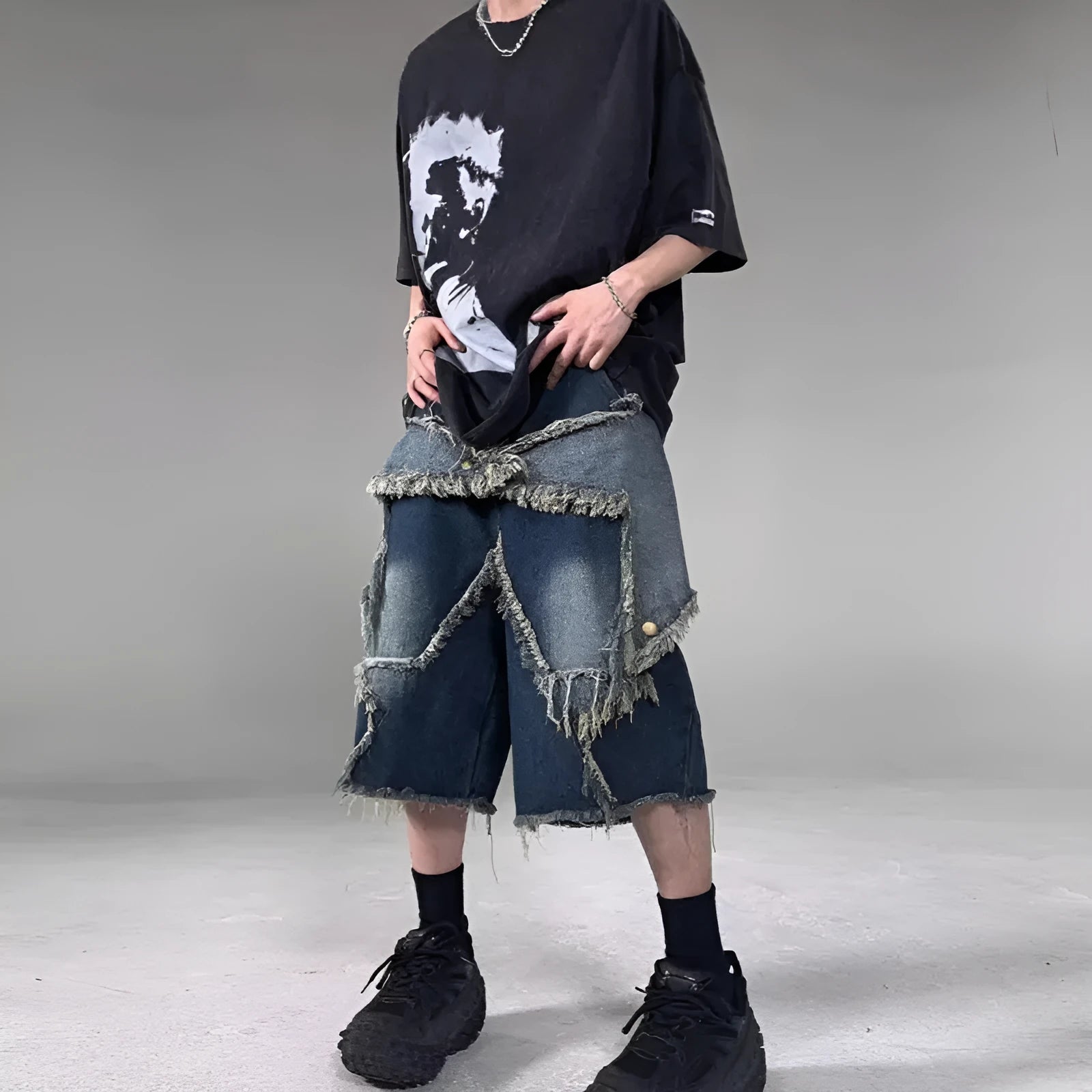 Blue men's loose-fit denim shorts with a frayed five-pointed star design on the leg.