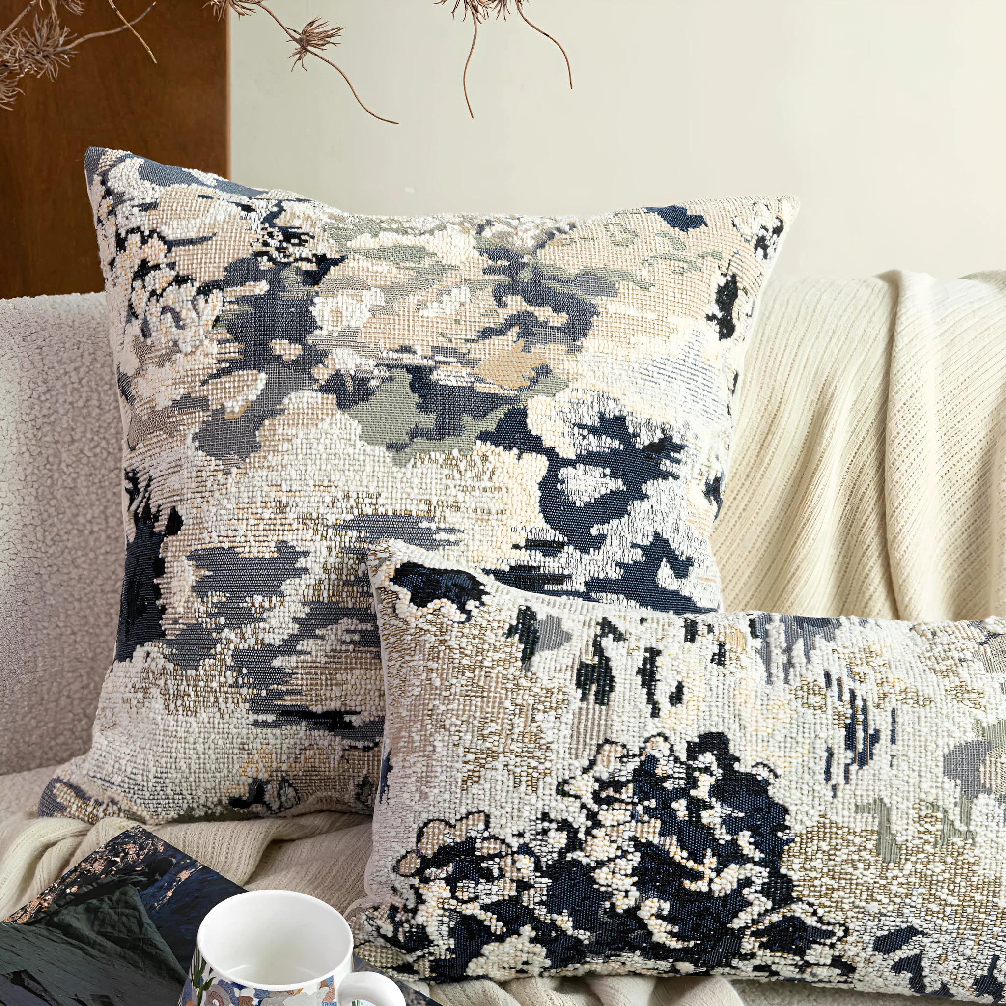 Antique blue floral patterned pillow on a sofa, shown in square and rectangular waist pillow sizes.