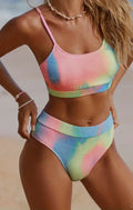 Women's tie-dye pleated split bikini in polyester fabric showing gradient pattern and textured detailing