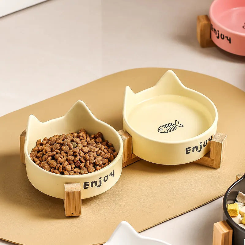 Porcelain cat bowl with wooden frame featuring cat paw pattern in pink colour