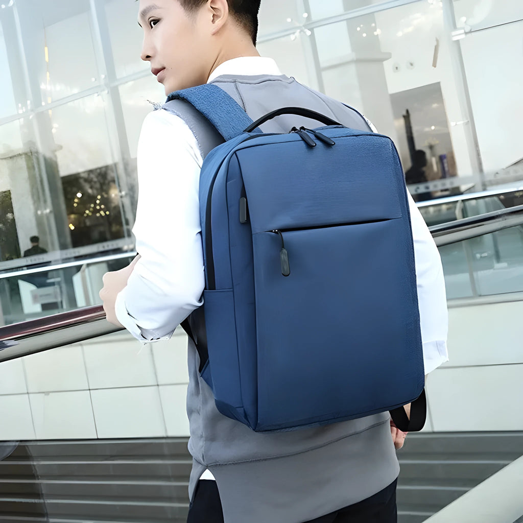 Large black sports backpack with curved shoulder straps showing USB charging port and 20-35 litre capacity