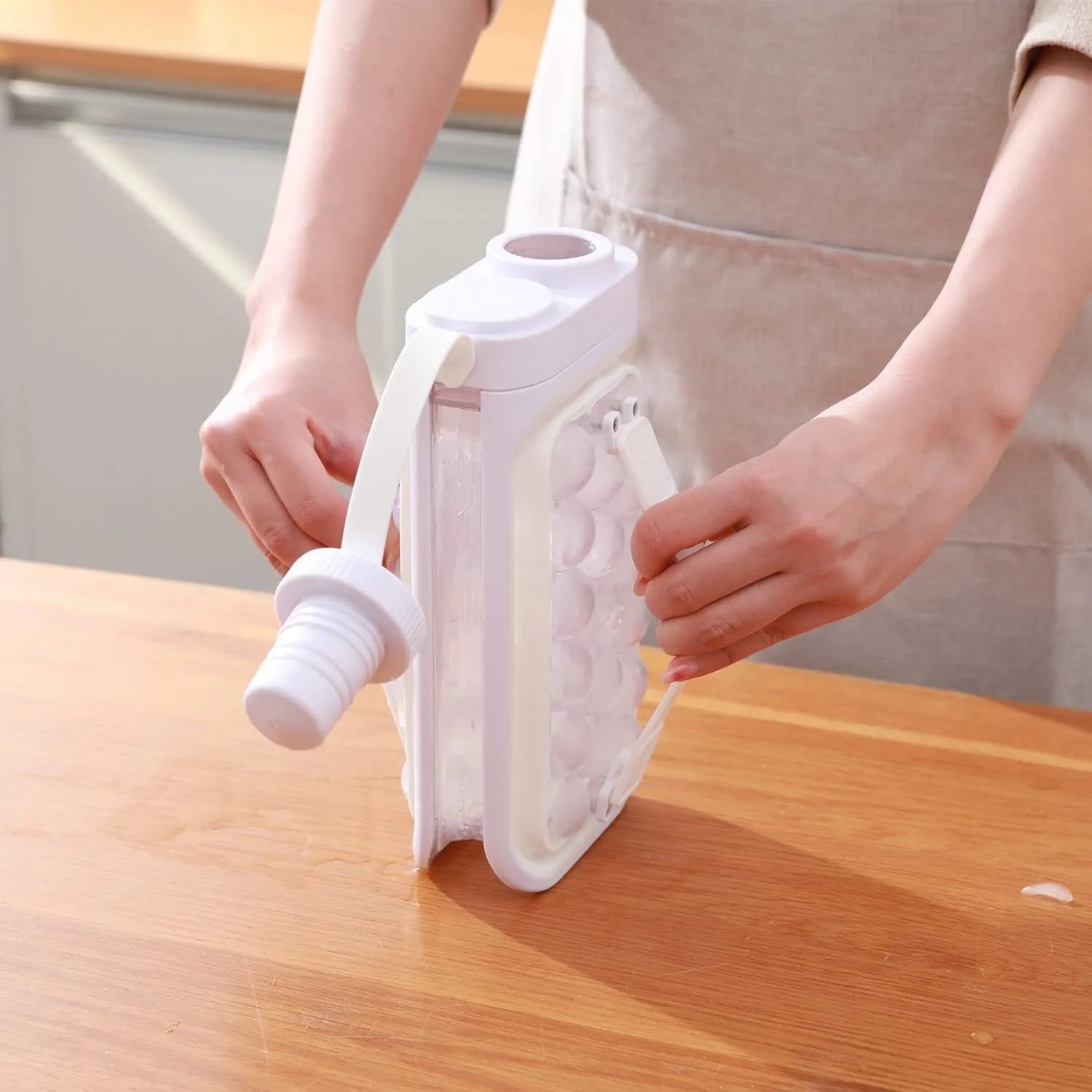 Light blue and white 2-in-1 ice ball tray and portable cold water bottle kitchen gadget.
