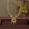 Green double-layer women's bracelet with safety lock bell pendant and drop-shaped charm