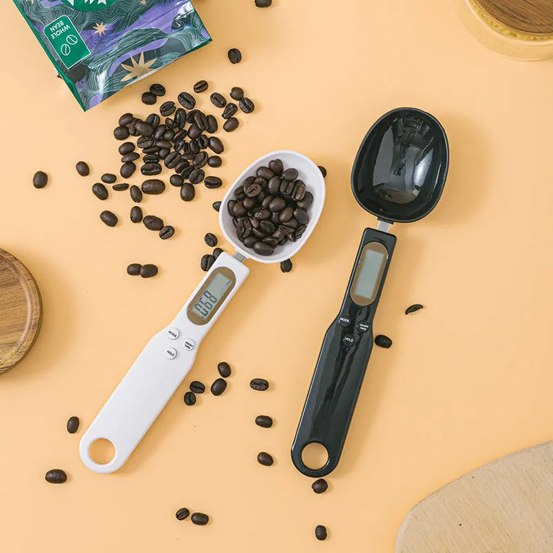 White digital spoon scale with LCD display showing weight measurement for kitchen ingredients