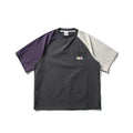 Dark grey loose fit T-shirt with contrast colour raglan sleeves on a hanger