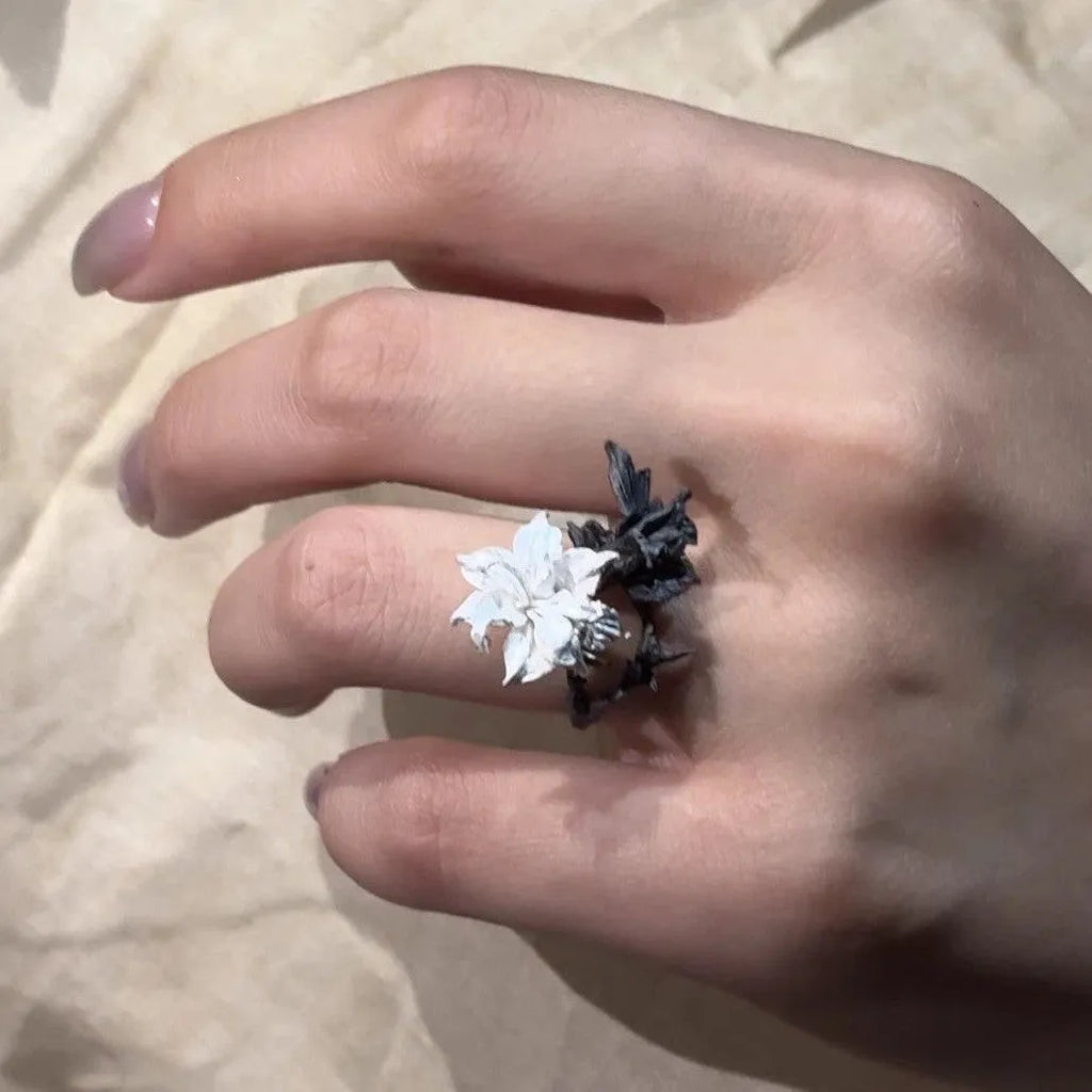 Bipolar Disorder French Simplicity copper ring in white and black with lily motif on neutral background