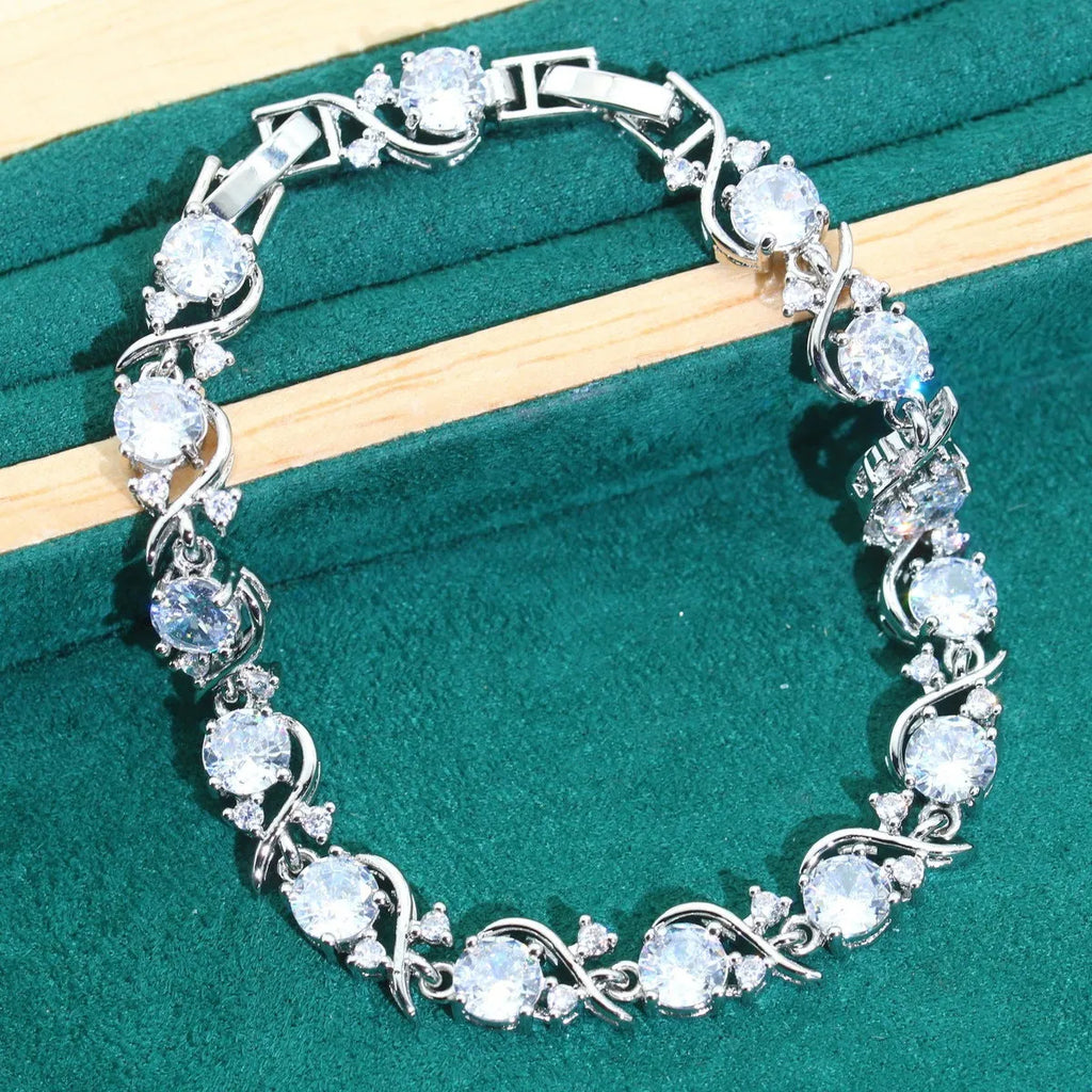 Bridal zircon jewellery four-piece set showing necklace, bracelet, earrings and ring with water wave chain