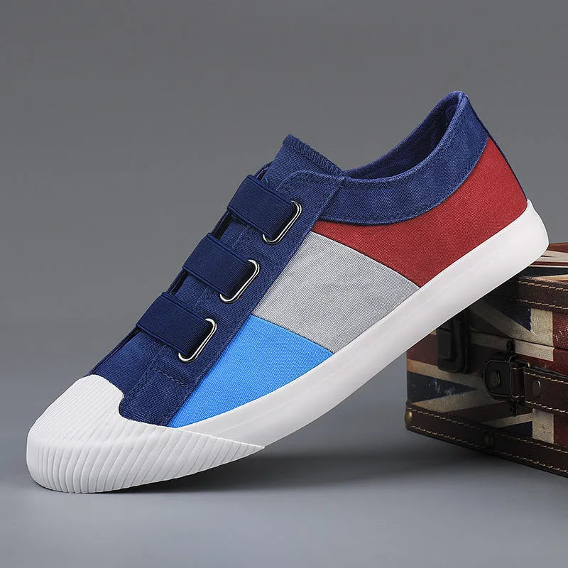 Men's low-top canvas sneaker with elastic band, round toe, and vulcanised rubber sole in beige colour.
