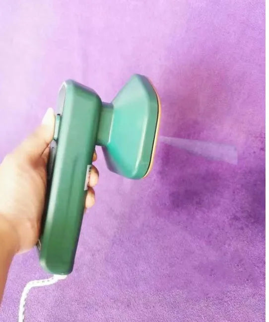 Dark green portable hanging ironing machine with ceramic panel and handheld design.