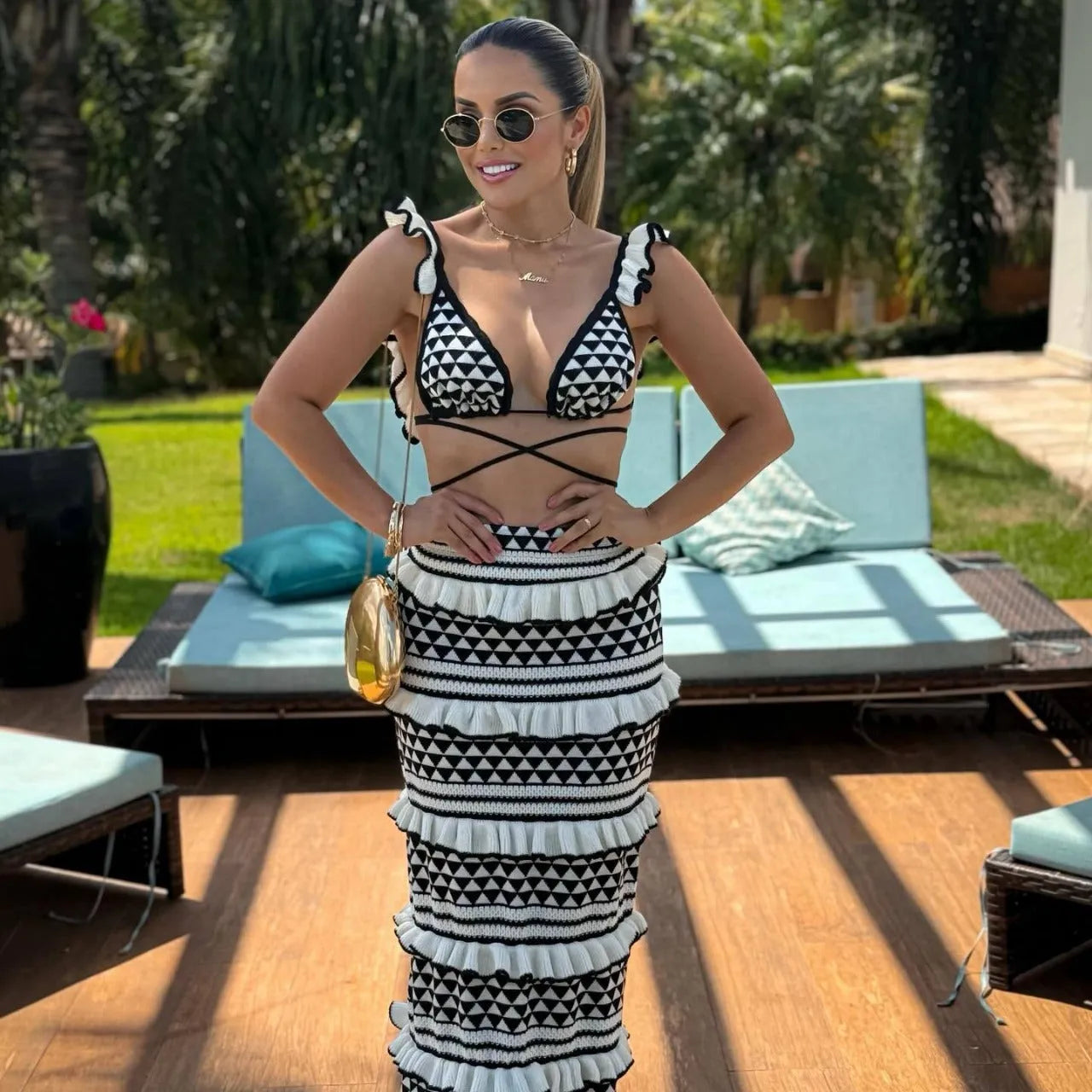 Black and white striped women's bikini top with ruffled straps and matching long knitted skirt.