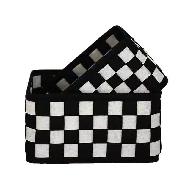 Black and white checkerboard patterned felt folding storage basket shown in its assembled box shape.