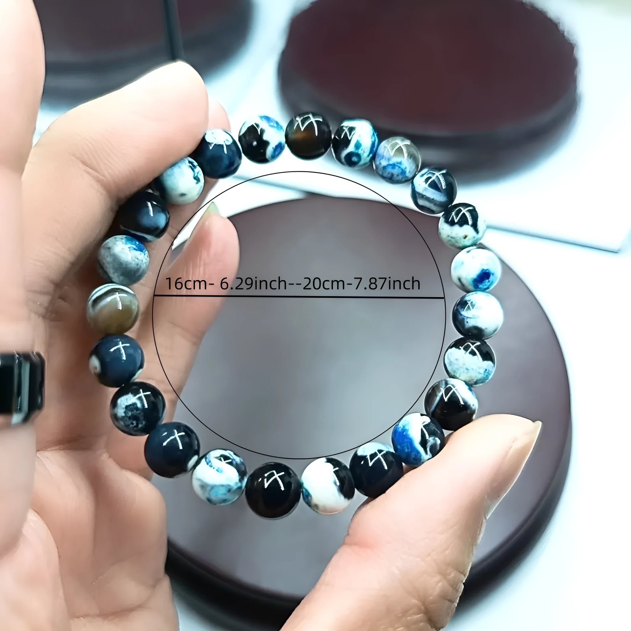 Close-up of a handmade Bohemian bracelet with round 8mm agate-style glass beads on a wrist.