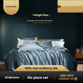 Silk four-piece quilt cover set in a solid light luxury colour, shown on a bed.