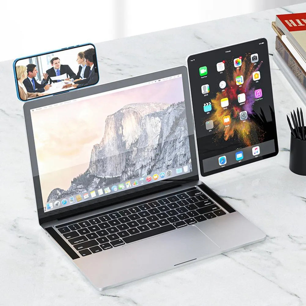 Black aluminum laptop phone holder with magnetic bracket mounted beside computer monitor