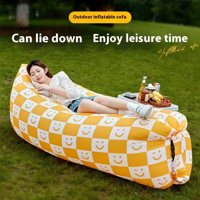 Portable inflatable sofa in folded position showing Oxford cloth material and compact 36cm x 27cm dimensions