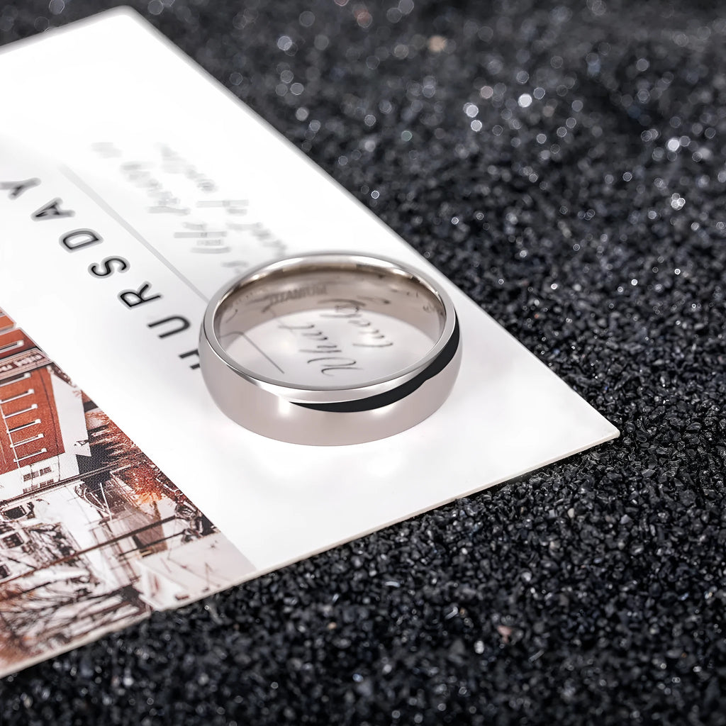 Silver titanium steel ring showing grinding finish, available in multiple widths and US sizes.