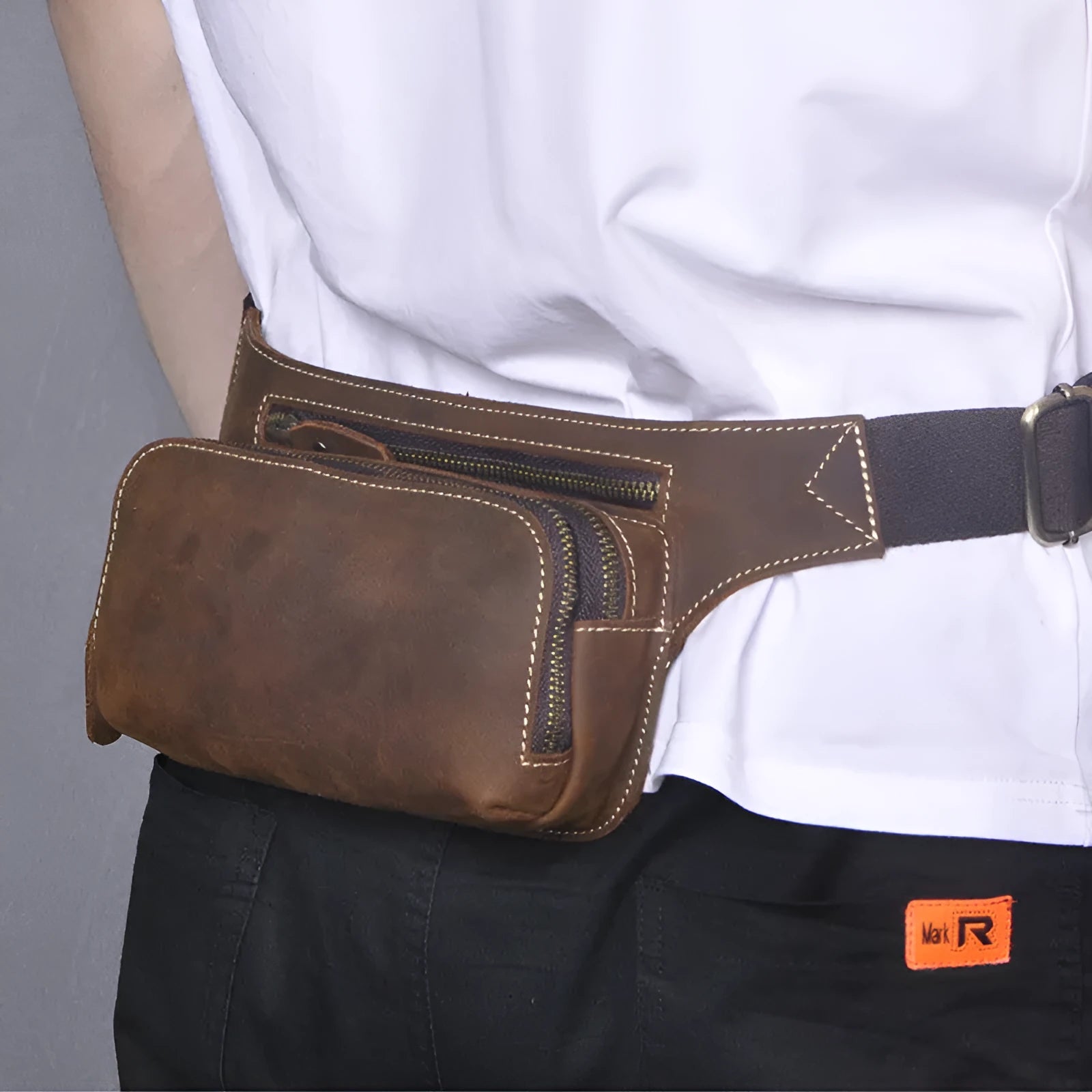 Brown cowhide leather men's sports waist bag with a pull-closure.