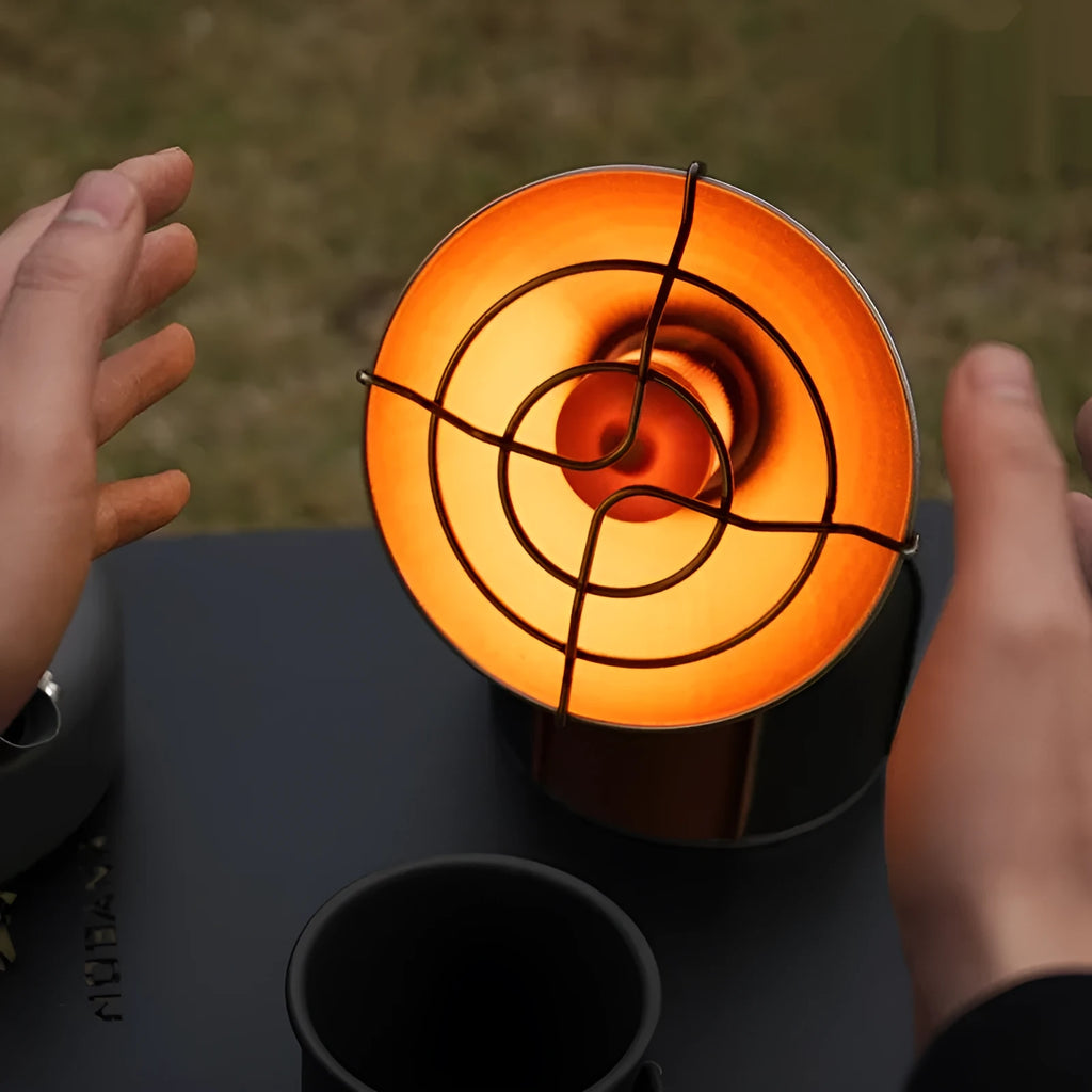 Black and orange portable outdoor camping heater with automatic ignition on a stainless steel and plastic body.