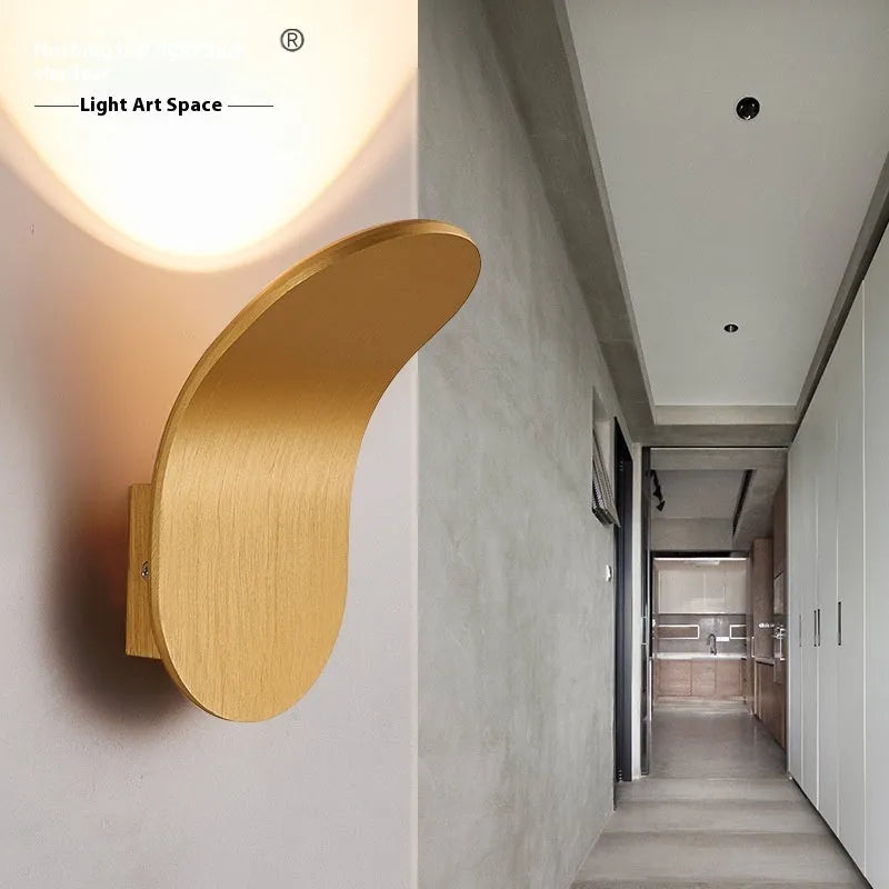 Modern simple wall lamp in brushed gold finish mounted on living room wall