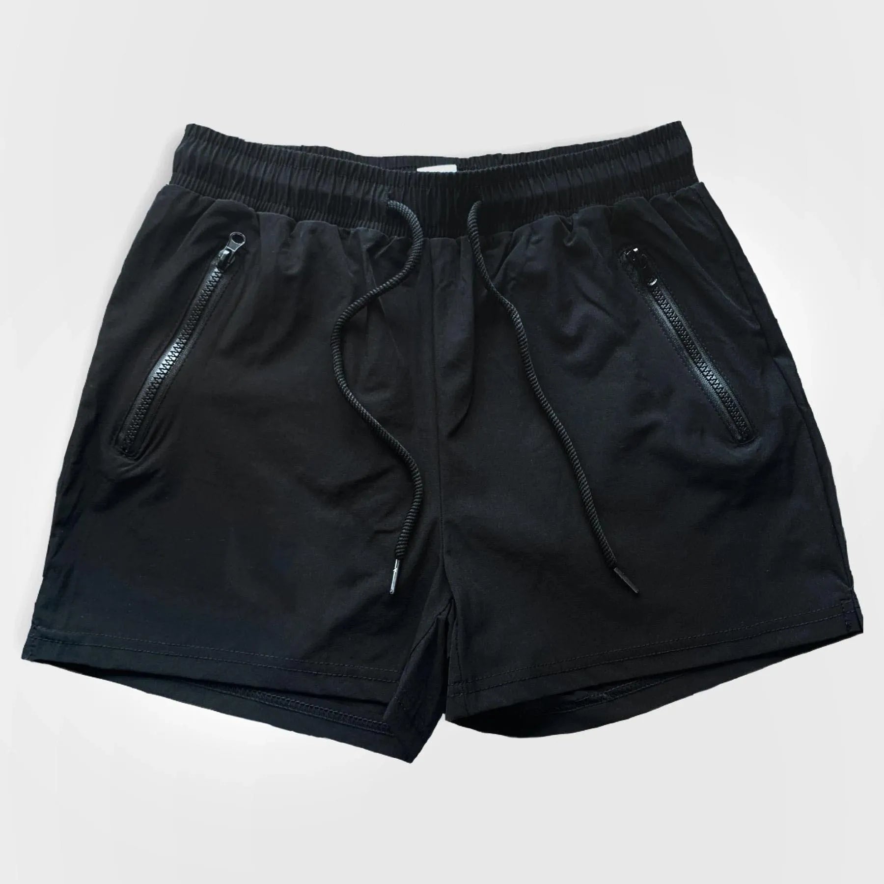 A man wearing blue quick-drying polyester sports shorts with a mid-waist design, suitable for casual summer and athletic activities.