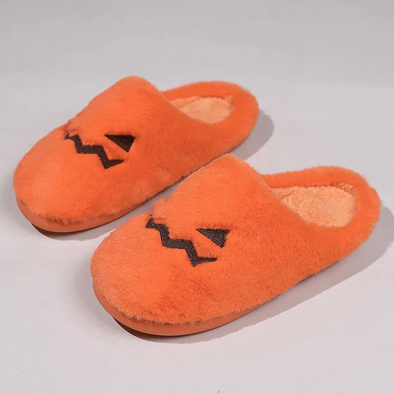 Orange Halloween pumpkin-themed plush indoor slippers with a coral velvet upper and non-slip PVC sole.