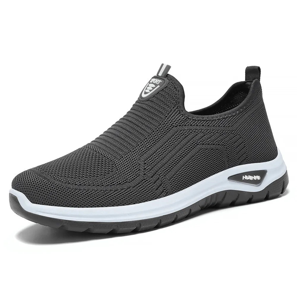 Men's black and grey casual tennis shoes with mesh lining and flat PVC sole.