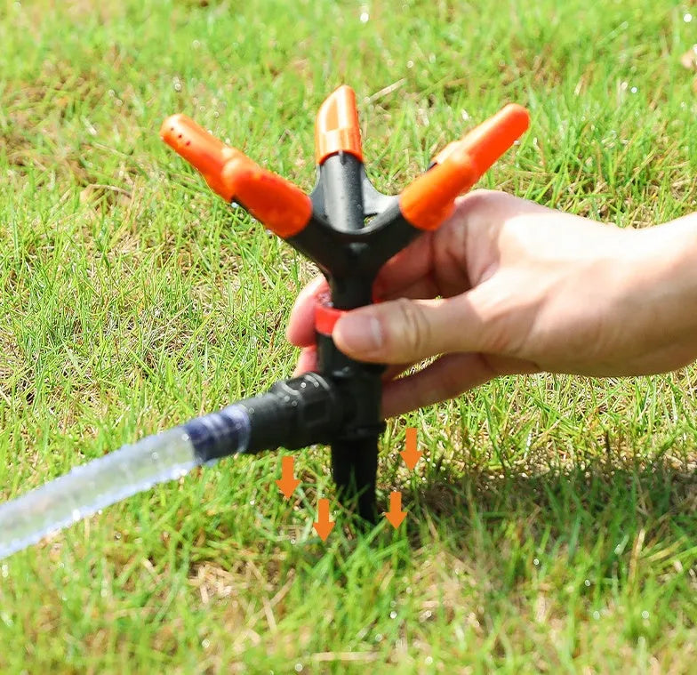 Orange plastic garden insert sprinkler with rotating water spray nozzle, 14x26.5cm