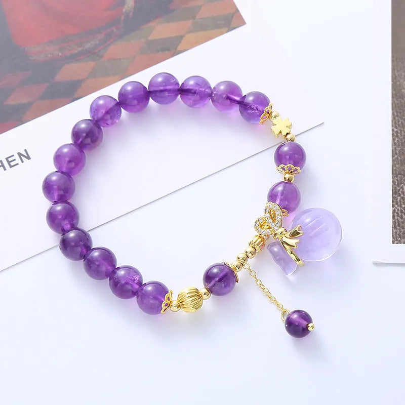 Purple amethyst bracelet with money bag pendant and peace buckle on wrist