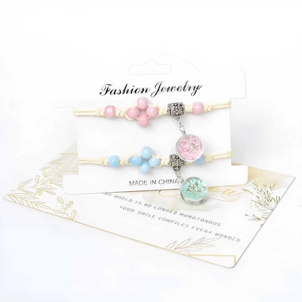 Close-up of a women's bracelet with large glass beads containing dried flowers, shown in a blue colour variant.
