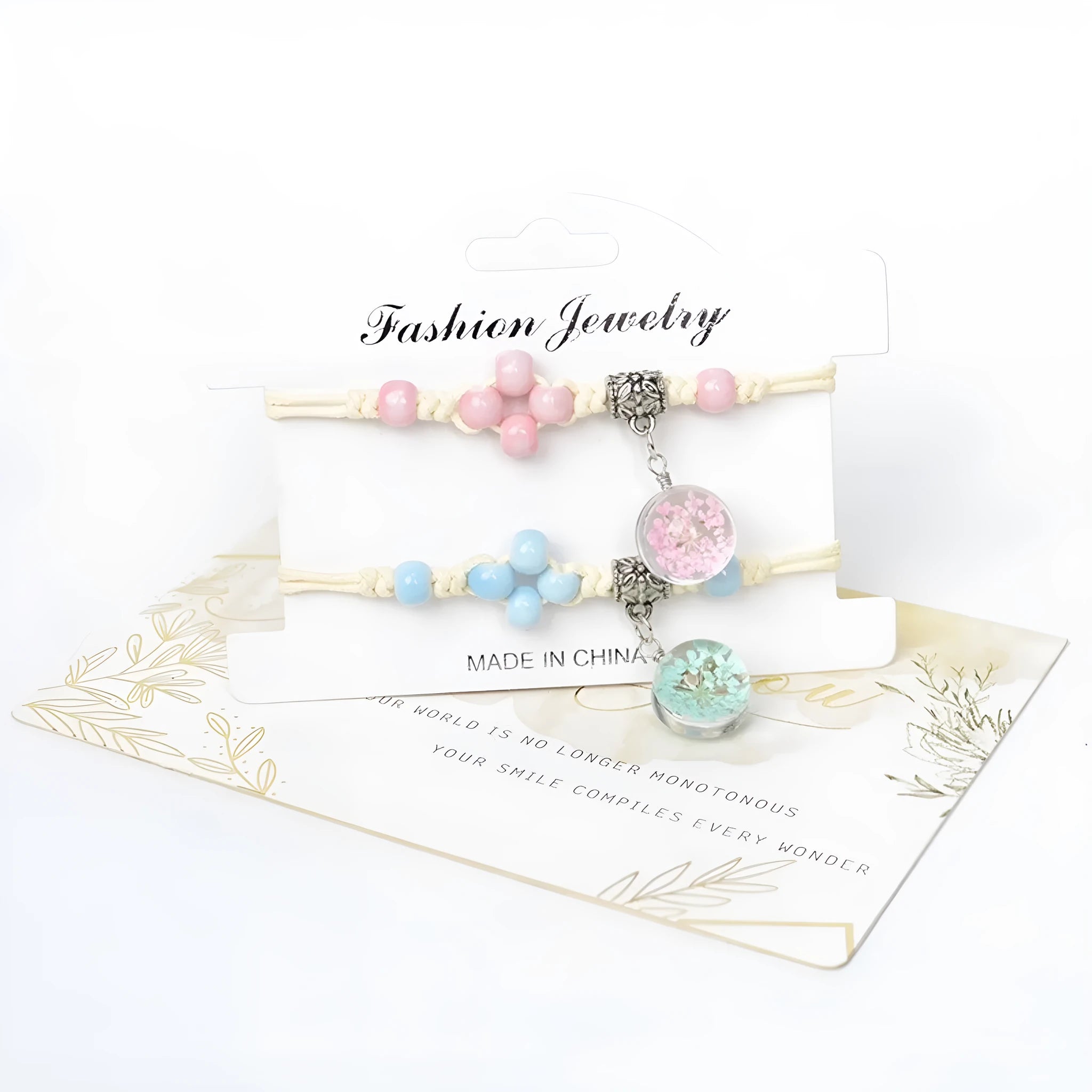 Close-up of a women's bracelet with large glass beads containing dried flowers, shown in a blue colour variant.