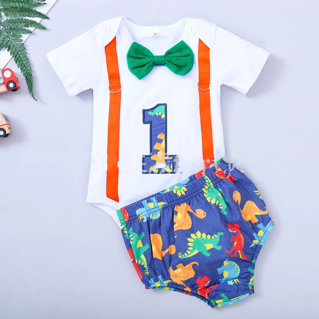 Baby or toddler wearing a soft cotton summer romper overall with shorts, in a choice of dinosaur or polka dot print colours.