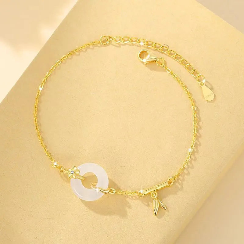 Women's silver bracelet with peace buckle clasp and white chalcedony gemstones in gold finish