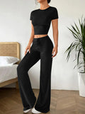 Black high-waist trousers and regular-sleeve T-shirt matching set for women laid flat.