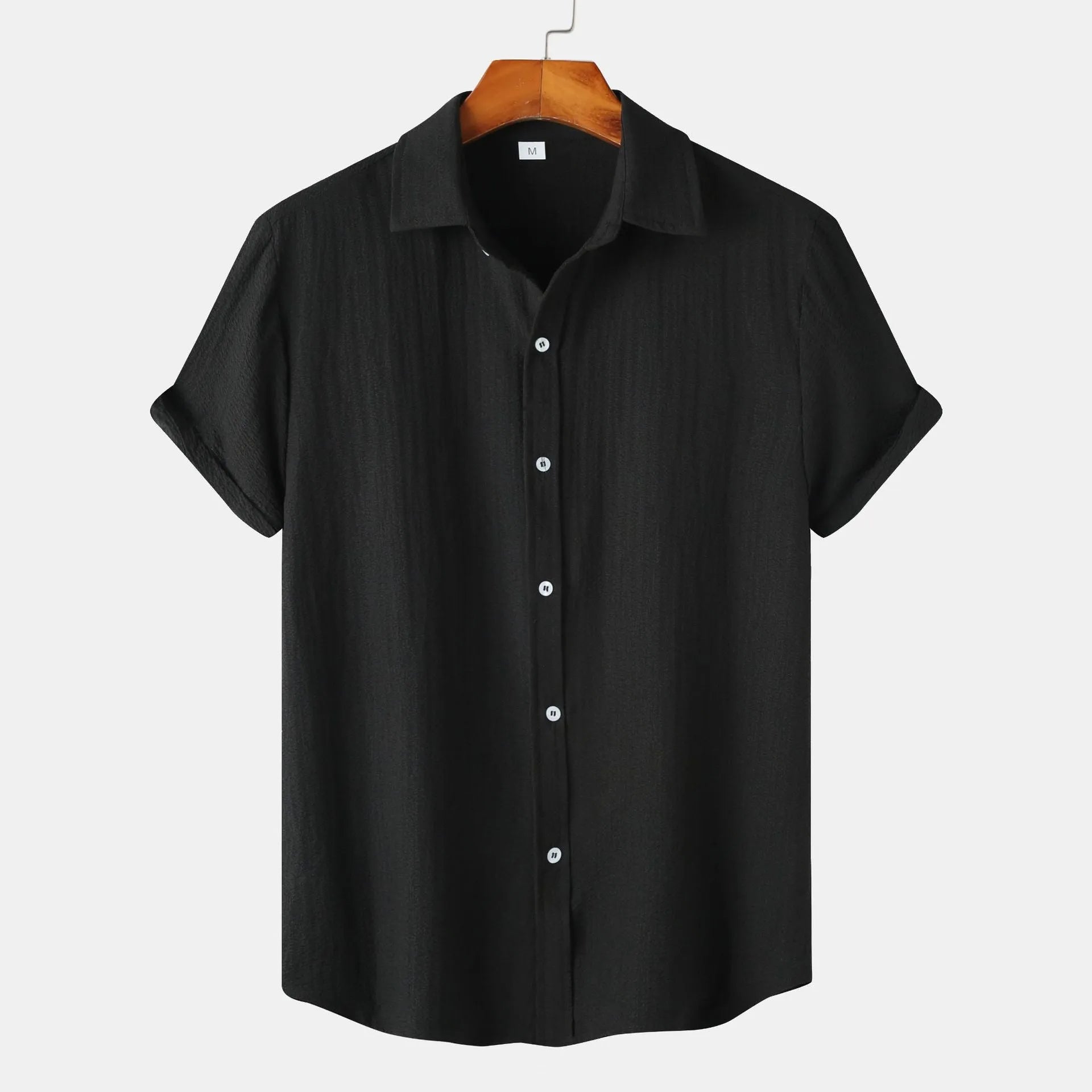 Man wearing a casual short-sleeved polyester shirt in a cardigan style, available in multiple colours.
