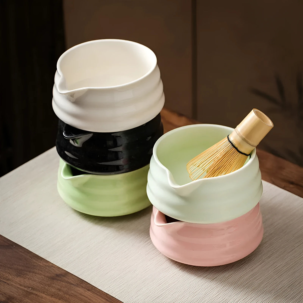 Ceramic Japanese style tea whisk stand in green or pink, listed size 53*40*46, holding a matcha whisk upright