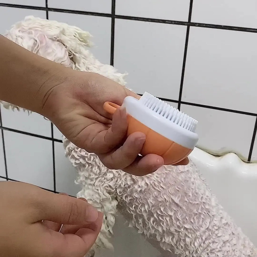 Orange TPR dog bath brush with shampoo dispenser and pumpkin-shaped grip for pet grooming