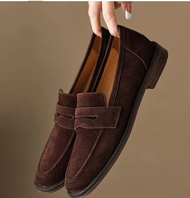 Women's suede leather flat loafers in black or brown, slip-on retro style with low heel under 3cm and top pigskin lining.