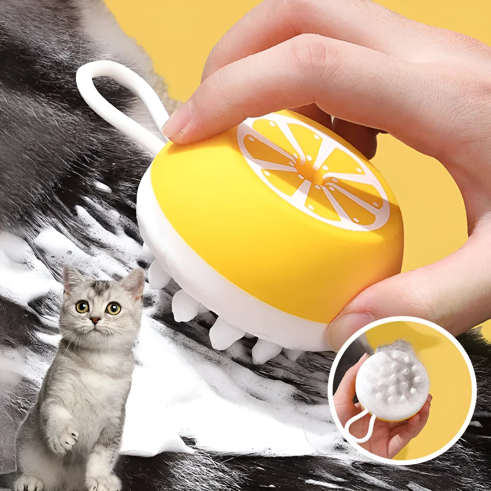 Yellow silicone pet bath brush with massage head and comb, shown next to a bottle of pet shampoo.