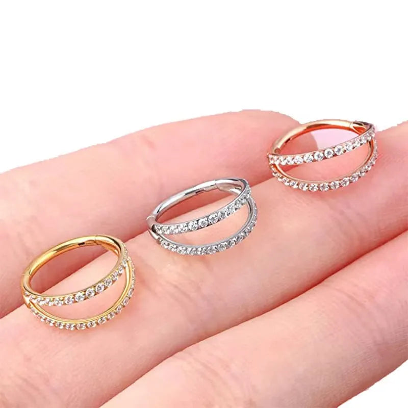 G23 titanium alloy nose ring with zircon detail in gold and steel colours, showing 1.0mm and 1.2mm diameter options.
