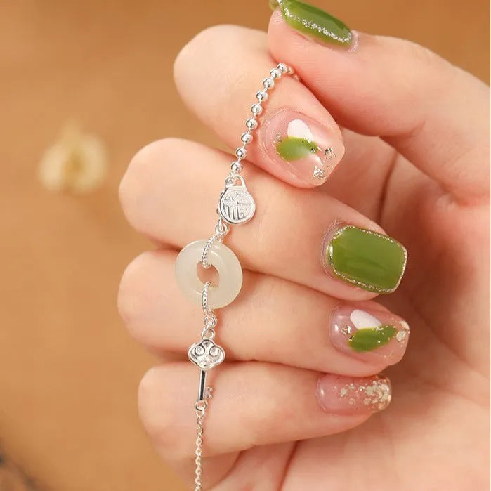 Silver bracelet with geometric peace buckle charm containing Hetian jade, traditional Chinese women's jewellery
