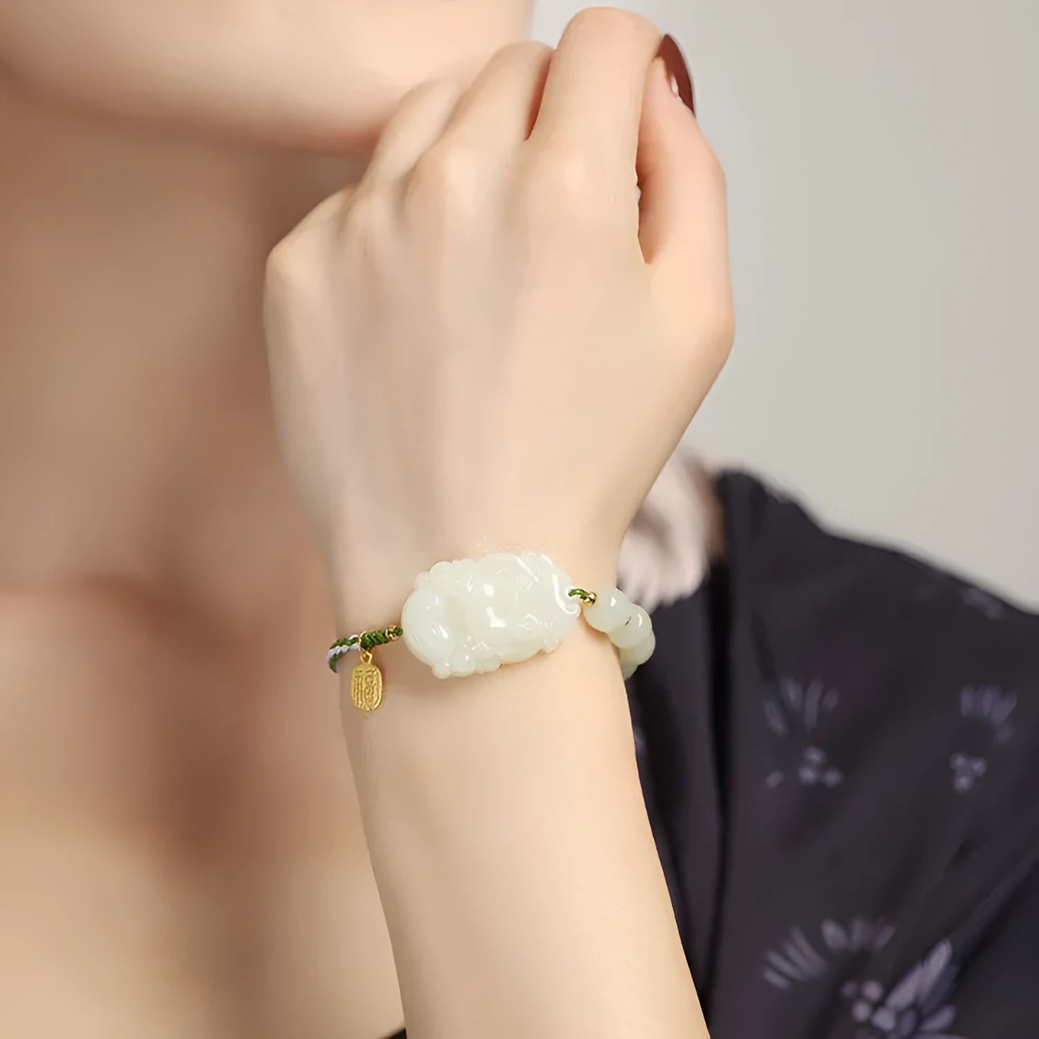Year of Rabbit red rope bracelet with Hetian jade bead and S925 silver card on a white background.