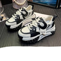 Women's black and white leather casual shoes with thick wedge sole and lace-up front.