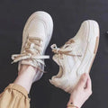 Women's low top sneaker in beige and pink with rubber sole