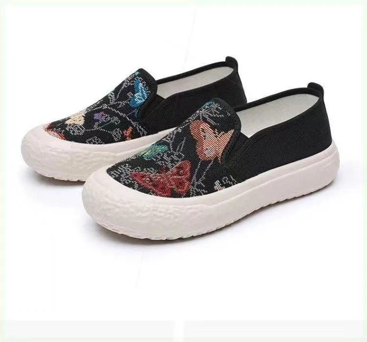 Women's black and white slip-on canvas shoes with round toes and plastic soles
