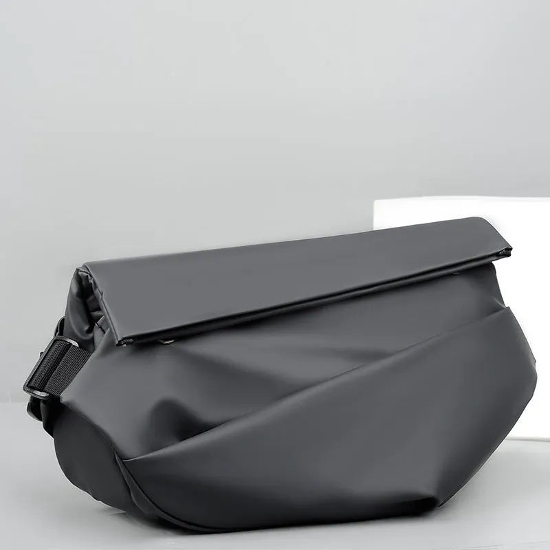 A medium-sized grey crossbody bag for men made from PU leather with a single shoulder strap.